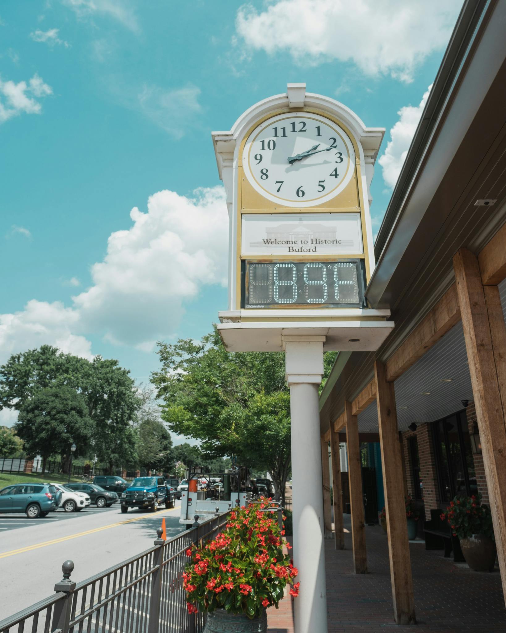 Charming street view of Buford's iconic clock under a bright blue sky.